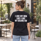 I Like My Men Like I Like My Ceiling Fan black graphic tee back print on female model at a cafe terrace