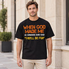 Black When God Made Me This'll Be Fun graphic T-shirt worn by a male model, front view with orange, cream and yellow lettering
