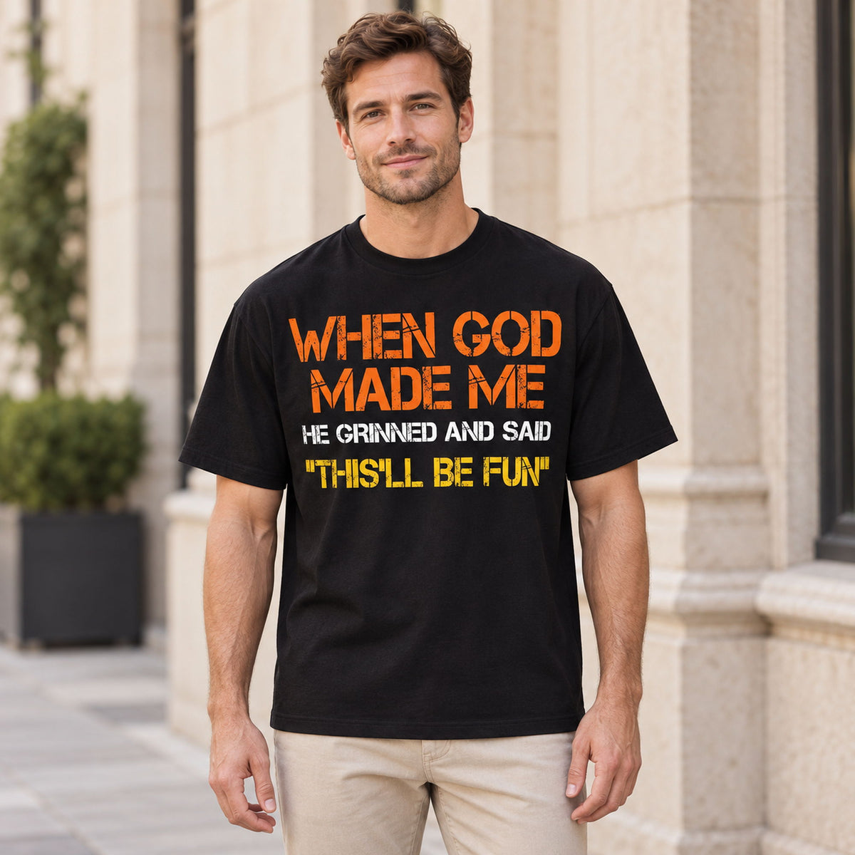 Black When God Made Me This'll Be Fun graphic T-shirt worn by a male model, front view with orange, cream and yellow lettering