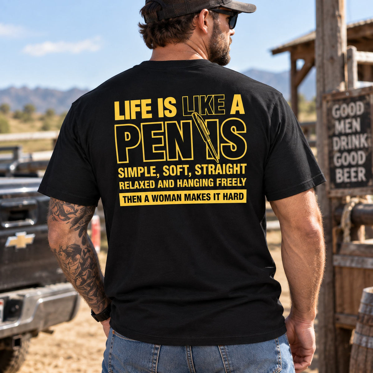 Life Is Like A Pen adult humor graphic tee in black, male model showing yellow back print outdoors