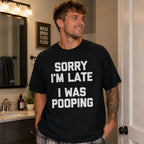 Sorry I'm Late I Was Pooping funny graphic tee black front bathroom lifestyle male model