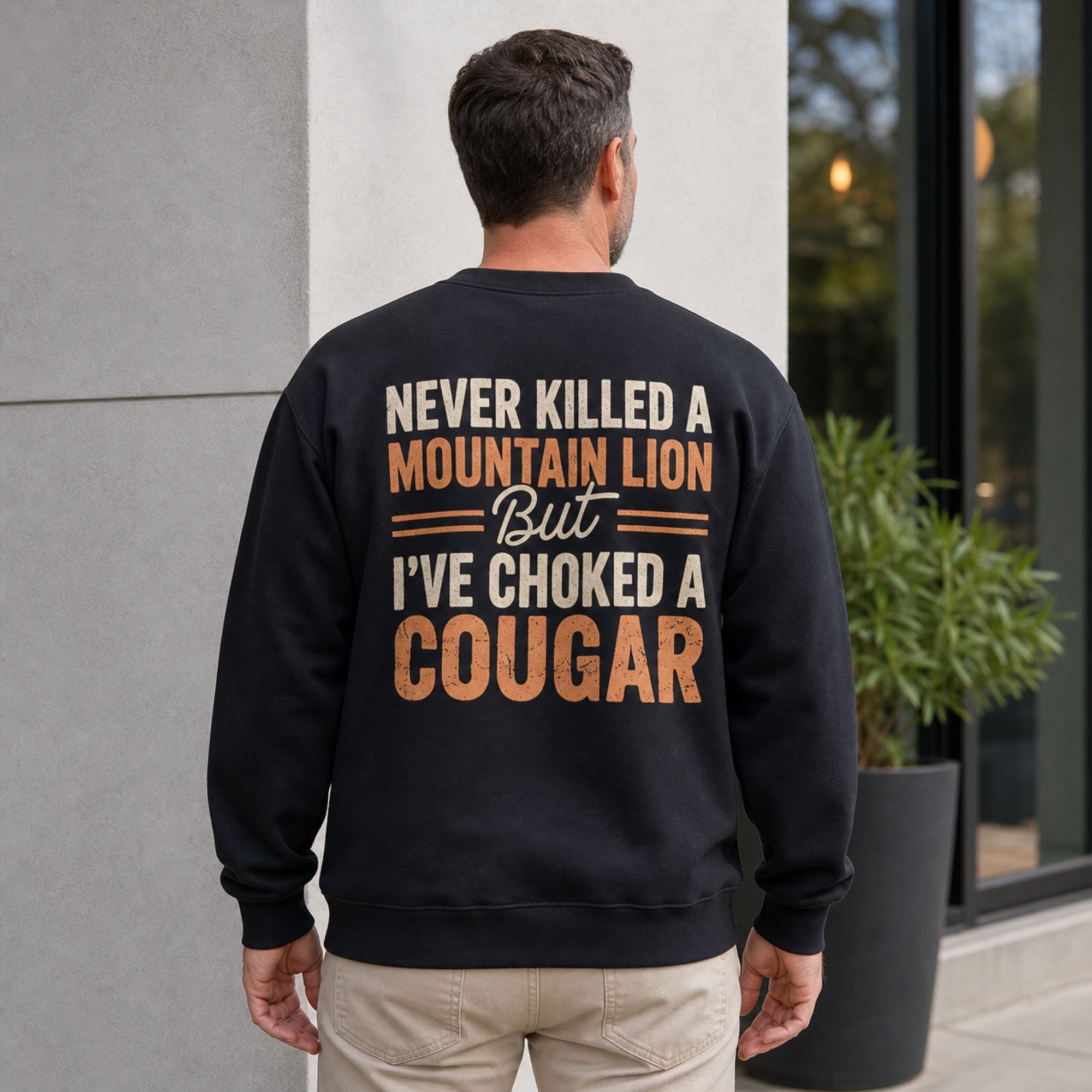 Never Killed a Mountain Lion cougar joke black crewneck sweatshirt back print on middle-aged male model