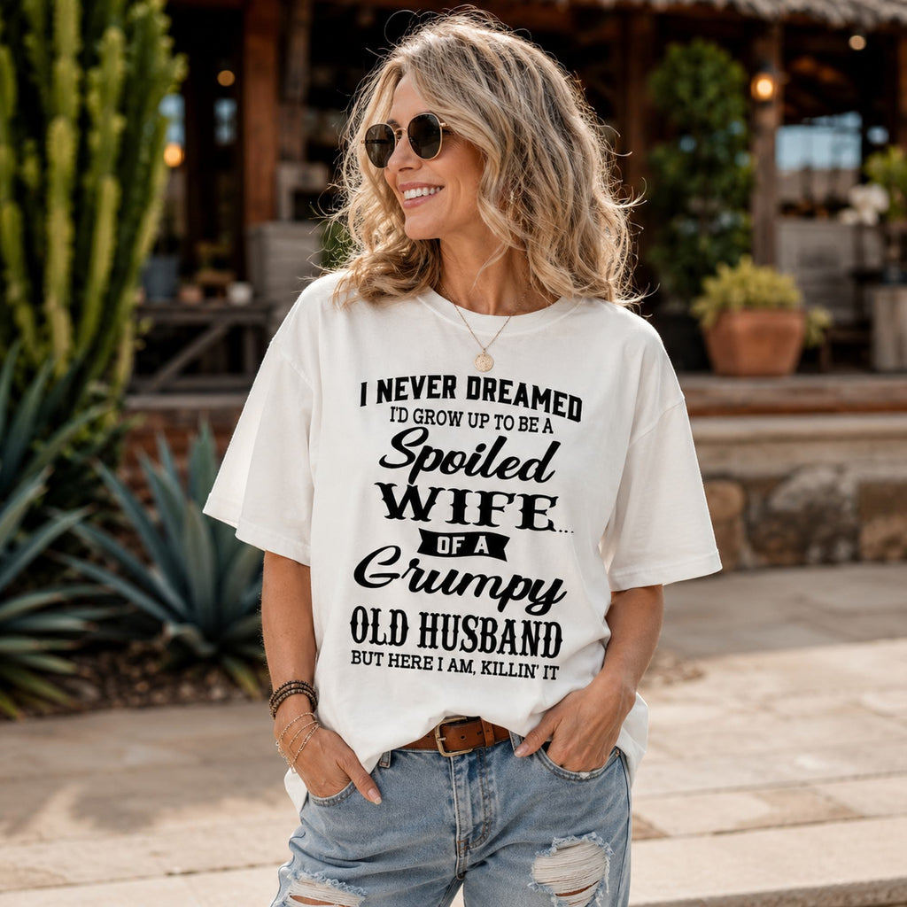 Spoiled Wife of a Grumpy Old Husband white front print graphic tee on a woman outdoors by a cactus patio