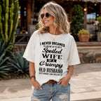 Spoiled Wife of a Grumpy Old Husband white front print graphic tee on a woman outdoors by a cactus patio