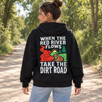 When The Red River Flows Take The Dirt Road black hoodie back print woman on a wooded path