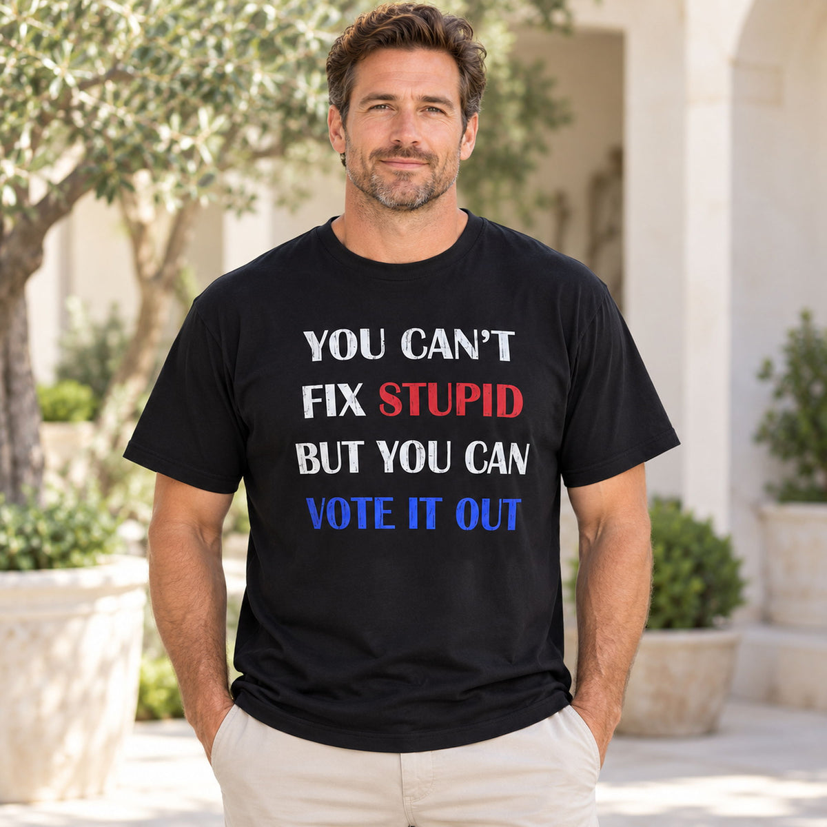 You Cant Fix Stupid But You Can Vote It Out red white blue slogan graphic on black T-shirt front, adult model photo