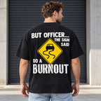 But Officer The Sign Said Do a Burnout yellow skidding-car sign graphic on black T-shirt back, adult model photo