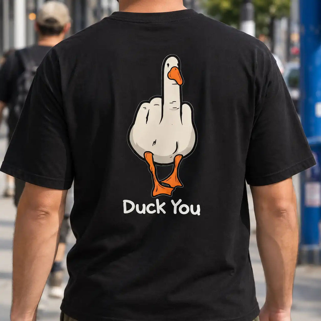 Duck You black T-shirt worn outdoors, showing the cheeky cartoon duck back graphic