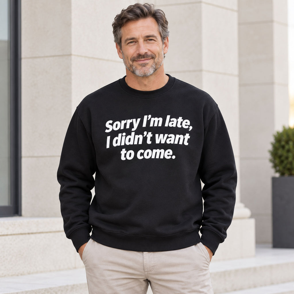 Sorry I’m Late sarcastic front print on a black sweatshirt, male model standing outdoors