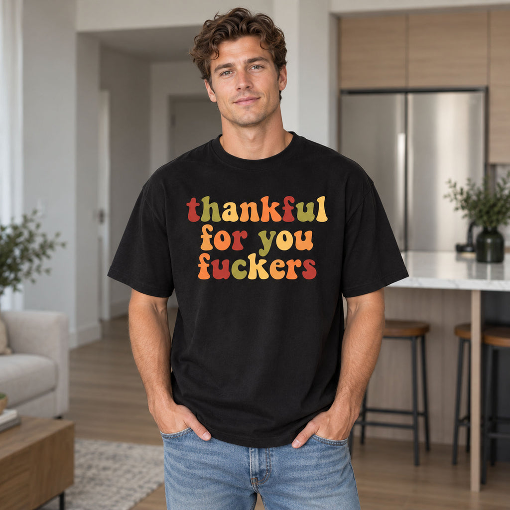 Black tee front on an adult male model with colorful retro Thankful For You Fuckers lettering