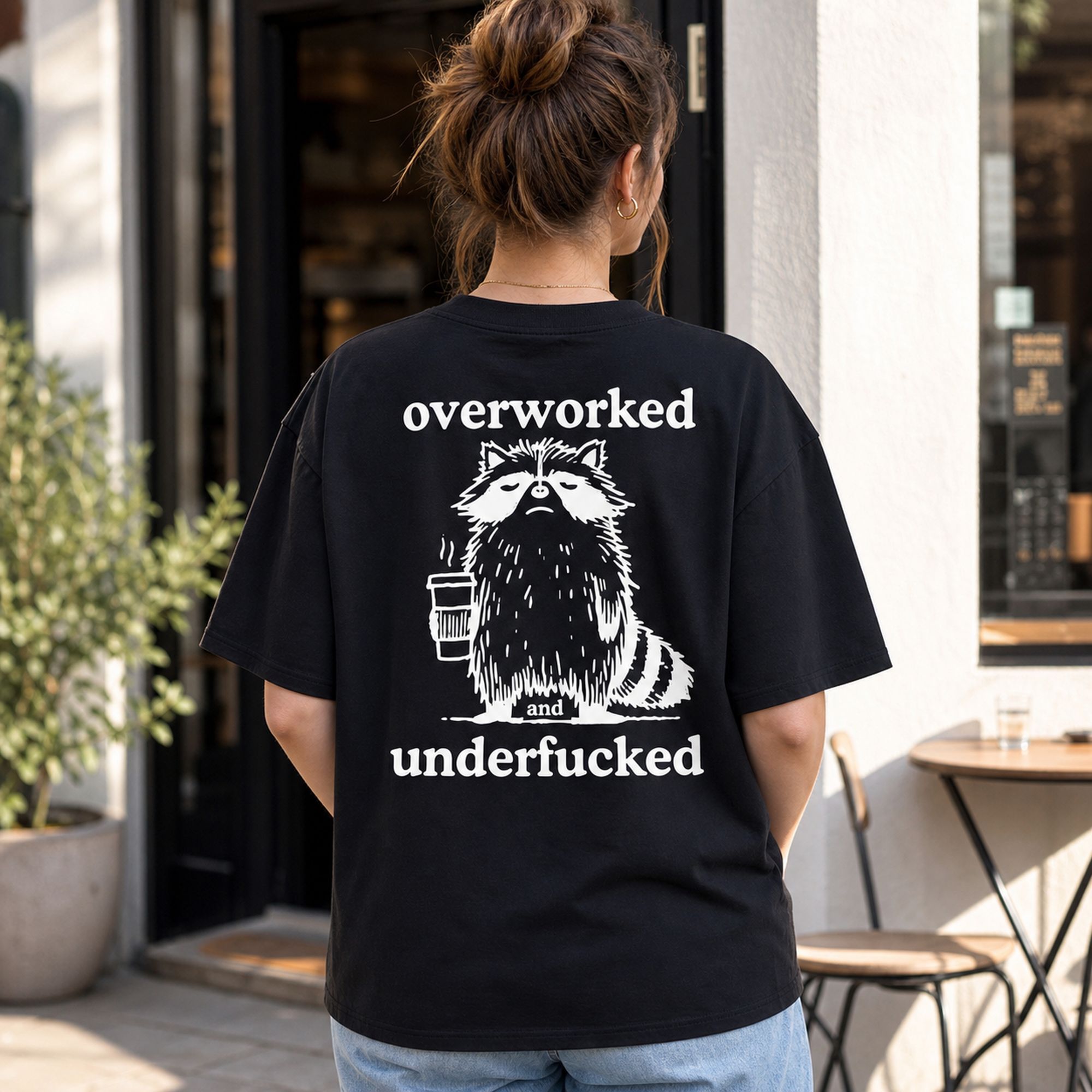 Overworked and Underfucked raccoon coffee graphic tee black back print female model