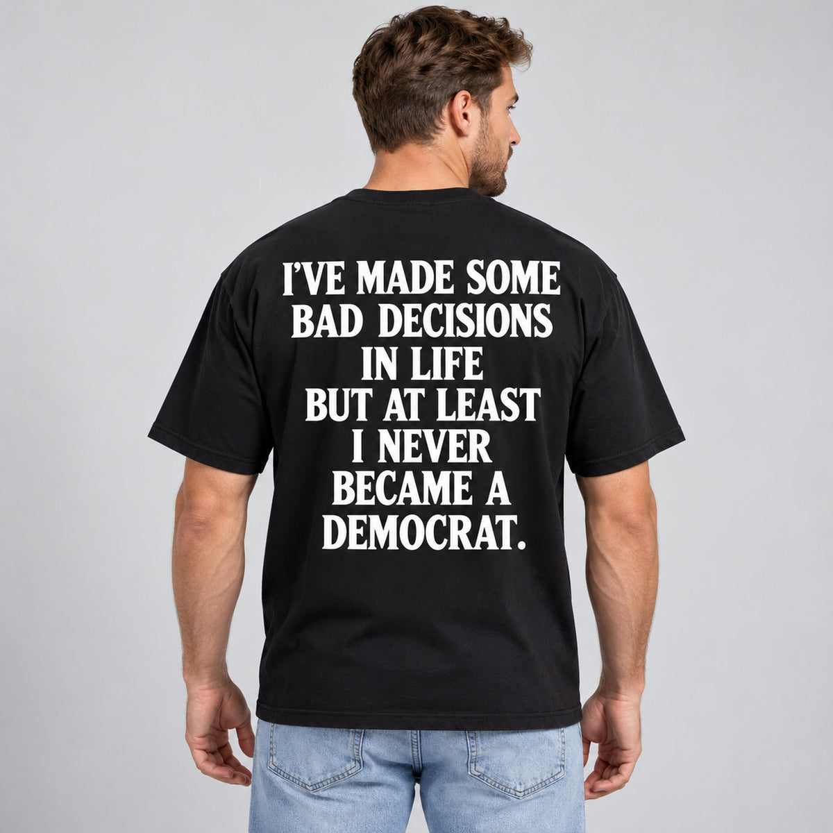 Never Became a Democrat statement black back-print tee on outdoor model