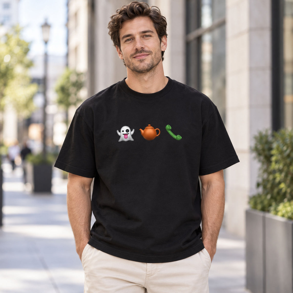 Black graphic tee on a front-facing male model with ghost, teapot and green telephone chest icons