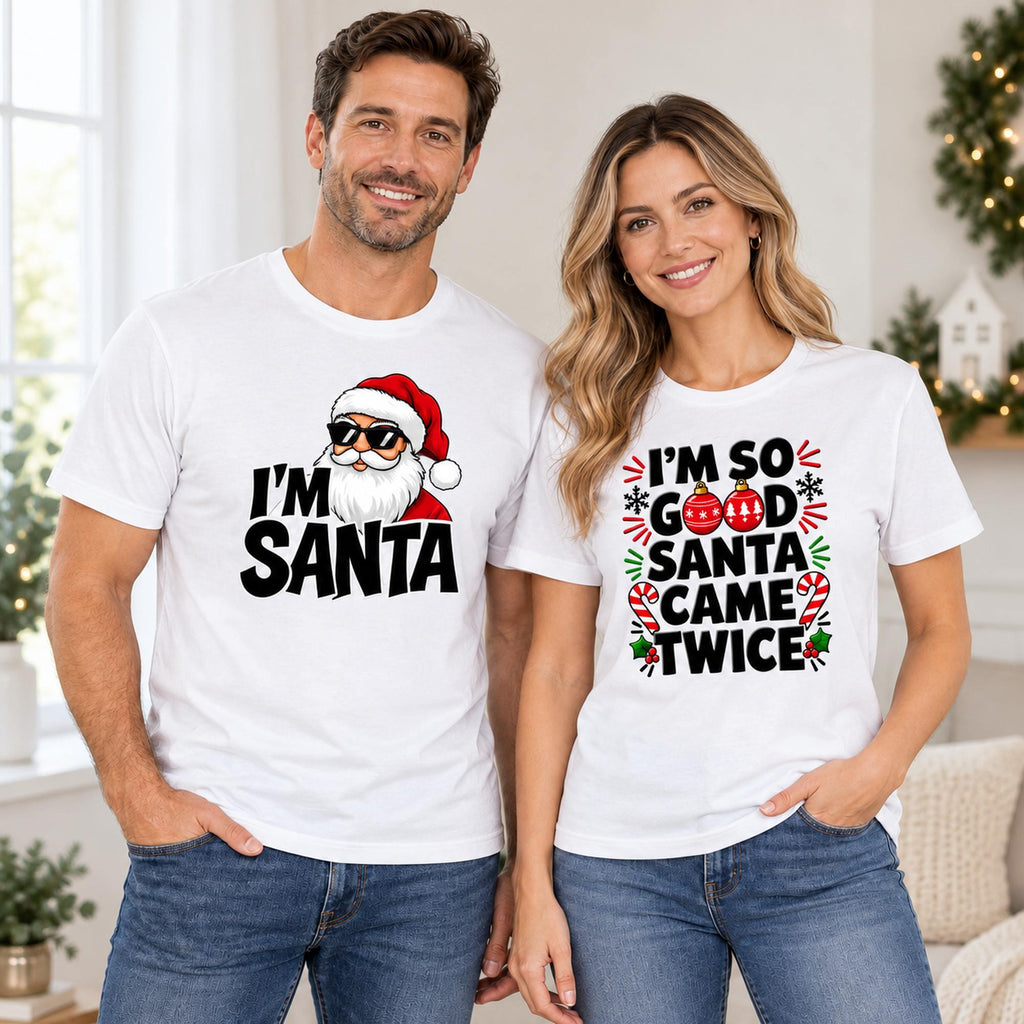 White I'm Santa and I'm So Good Santa Came Twice graphic tees shown on a couple in a Christmas setting