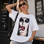 Cult glam horror portrait white graphic tee front view on a female model in a music store setting