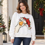 Christmas goose with Santa hat and lights on white crewneck sweatshirt front, adult female model by festive doorway