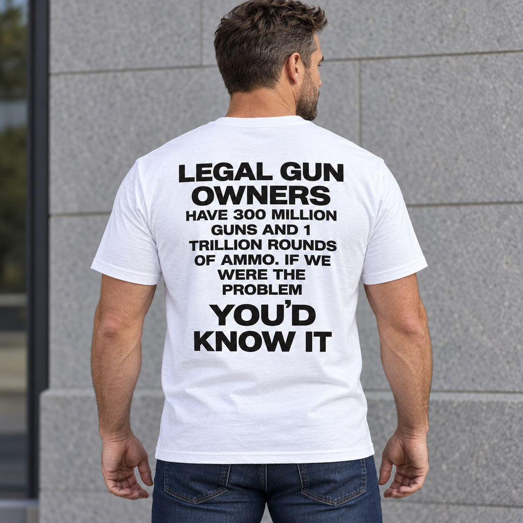 Legal Gun Owners statement back print on a white T-shirt, male model standing outdoors