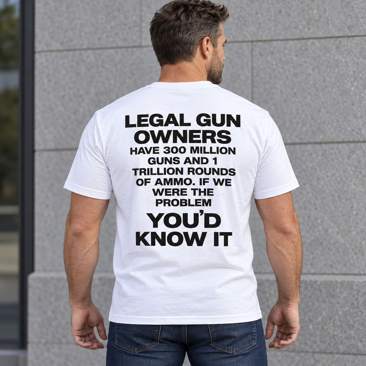 Legal Gun Owners statement back print on a white T-shirt, male model standing outdoors