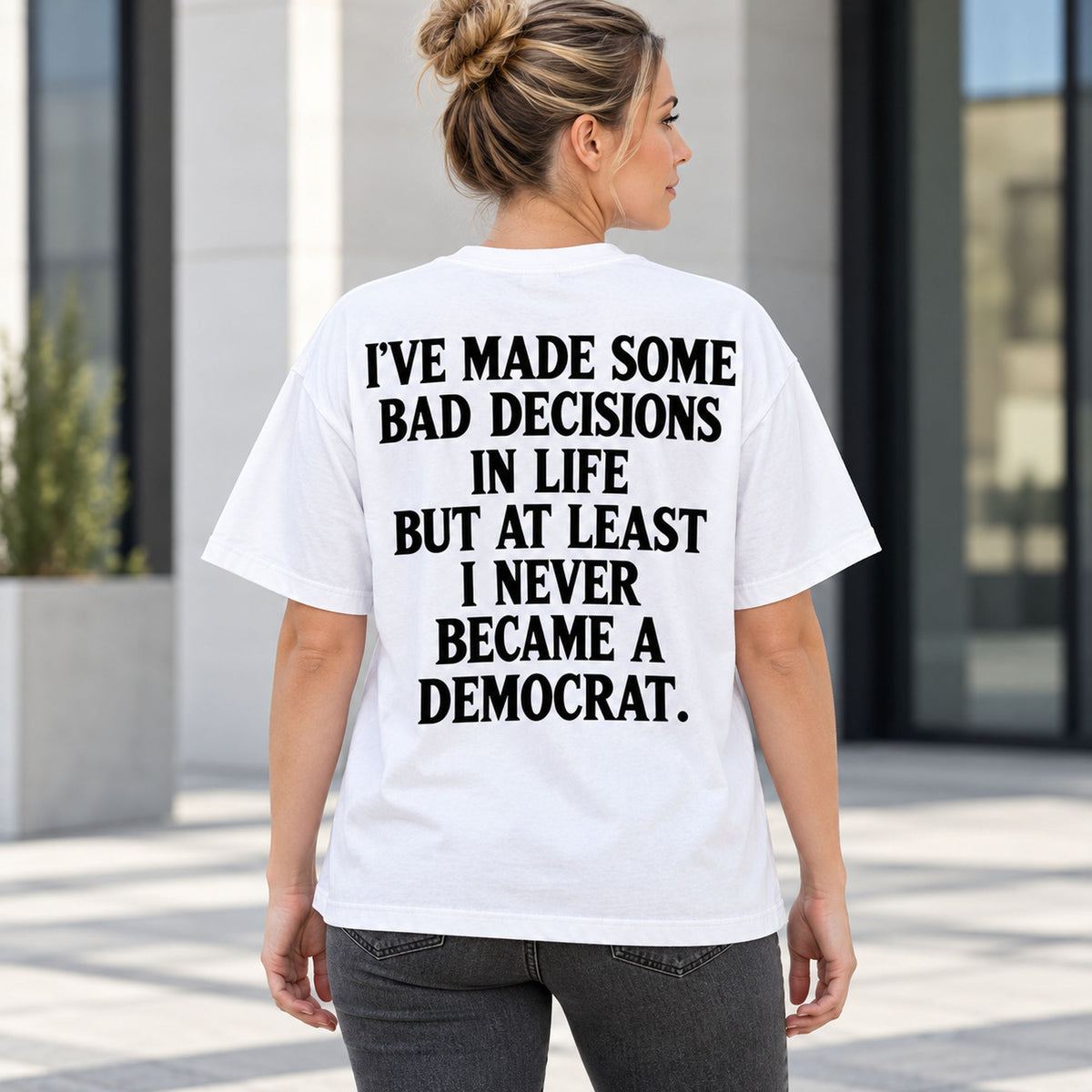 Never Became a Democrat statement white back-print tee on outdoor model