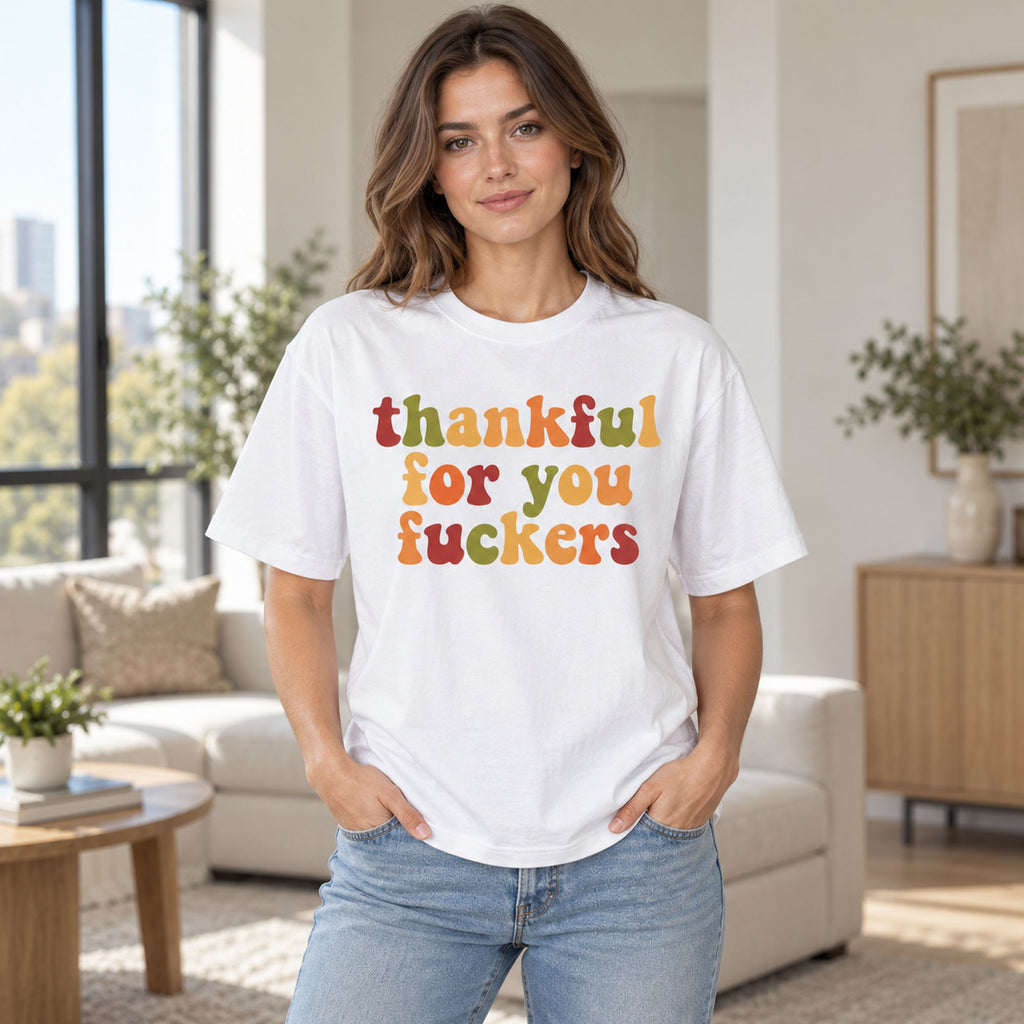 White tee front on an adult female model with colorful retro Thankful For You Fuckers lettering