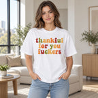 White tee front on an adult female model with colorful retro Thankful For You Fuckers lettering