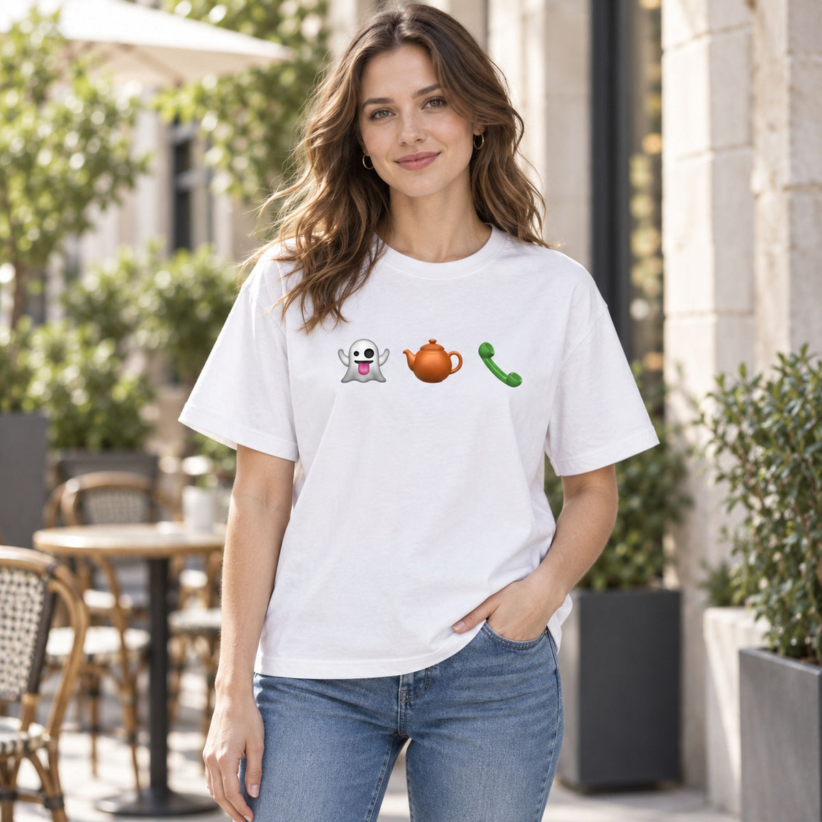 White graphic tee on a front-facing female model with ghost, teapot and green telephone chest icons