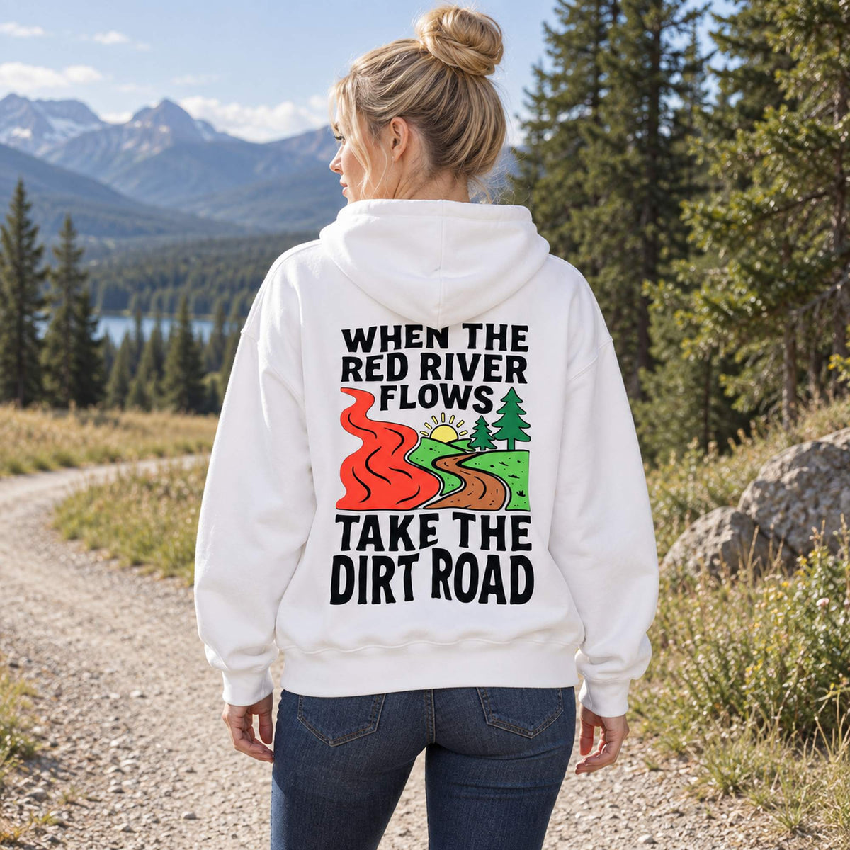When The Red River Flows Take The Dirt Road white hoodie back print woman by mountain scenery