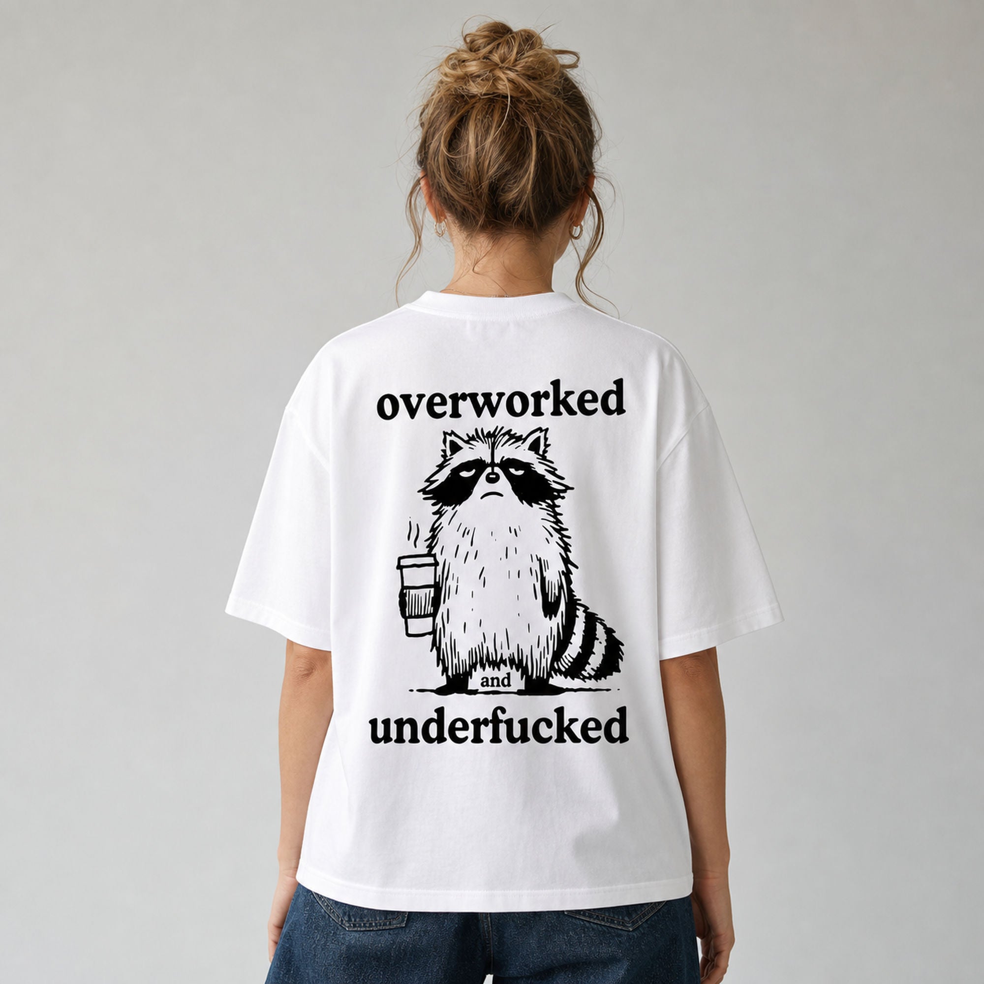 Overworked and Underfucked raccoon coffee graphic tee white back print female model