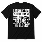 Black I Know My Man Is Older Than Me graphic tee, full back flat-lay with white slogan