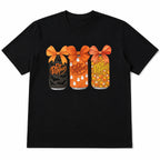 Black Dr Pepper Halloween bow cans front-print graphic tee, front flat lay on a white background