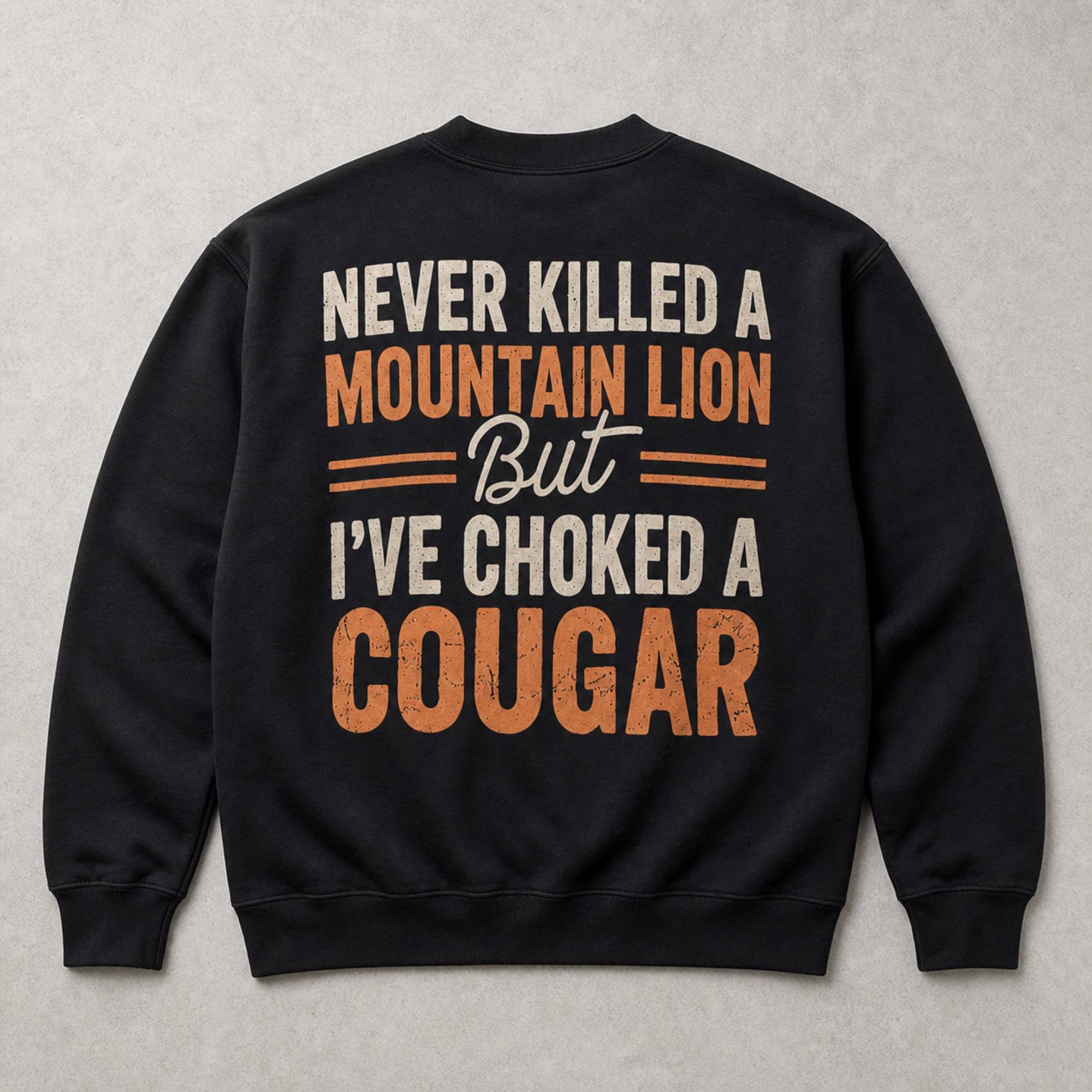 Never Killed a Mountain Lion cougar joke black crewneck sweatshirt back-side flat lay