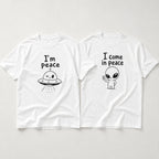I Come In Peace matching couple alien graphic tee white front flat lay