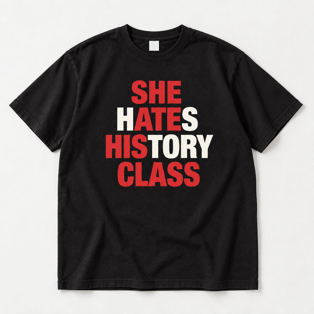 She Hates History Class black graphic T-shirt flat lay with red letter accents across four lines