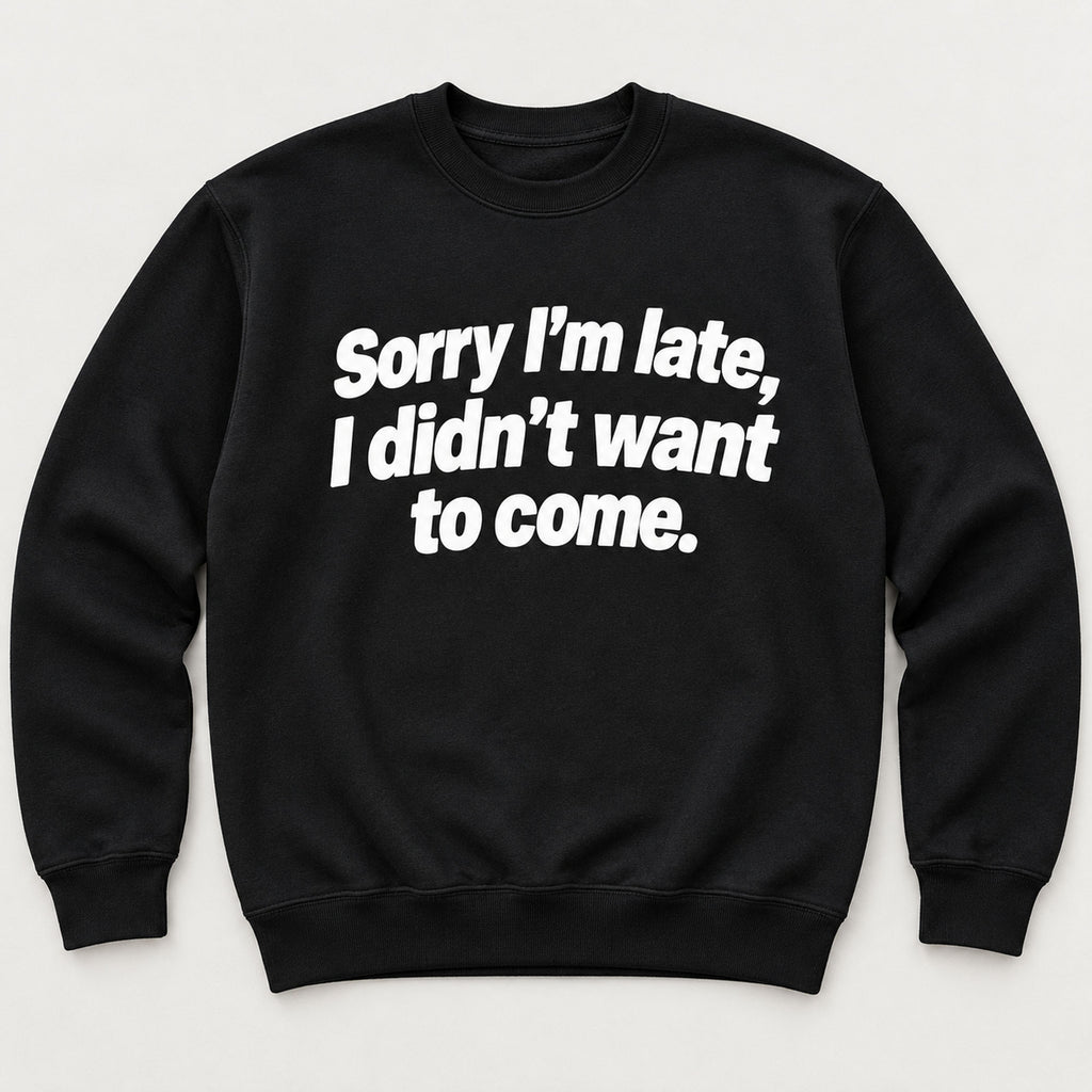 Sorry I’m Late sarcastic front print on a black sweatshirt, flat lay showing the complete lettering