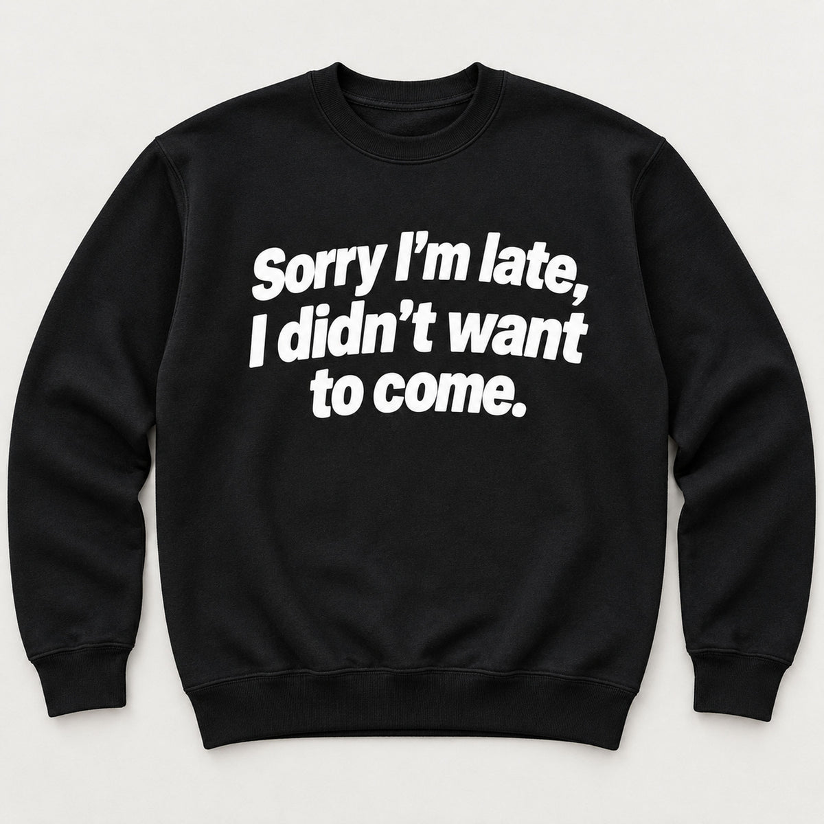 Sorry I’m Late sarcastic front print on a black sweatshirt, flat lay showing the complete lettering