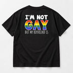 I'm Not Gay But My Boyfriend Is black tee flat lay, rear view with white text and rainbow back graphic