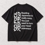Black T-shirt back flat lay with the complete Reading Japanese Is Really Easy sideways-reading print