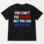 You Cant Fix Stupid But You Can Vote It Out red white blue slogan graphic on black T-shirt back, flat lay showing complete print