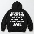 Let God Fix It because if I fix it I am going to jail slogan on black hoodie back, flat lay showing complete print