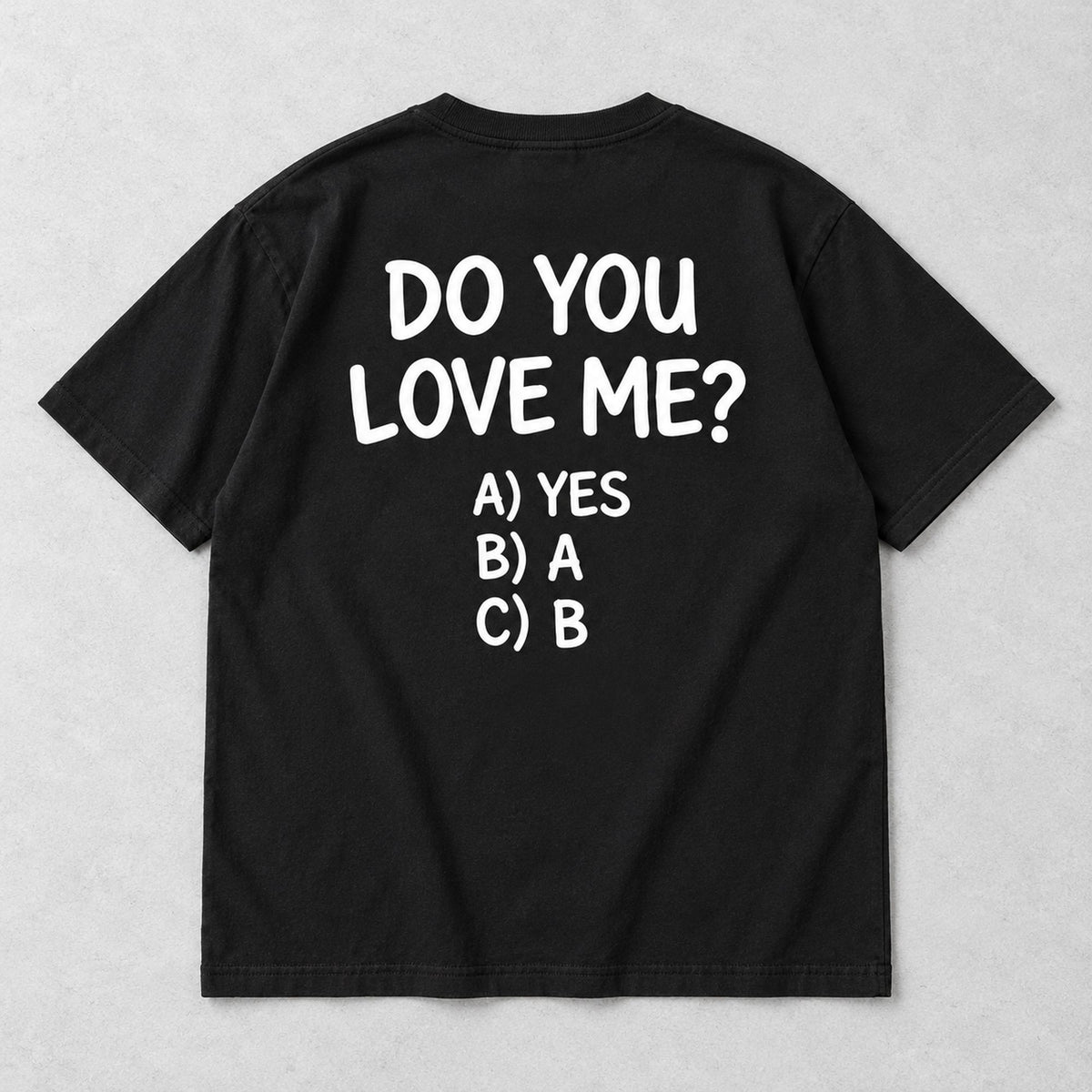 Black graphic tee back flat lay with Do You Love Me design