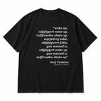 Black tee front flat lay with Wake Up scrambled text and Serj Tankian attribution