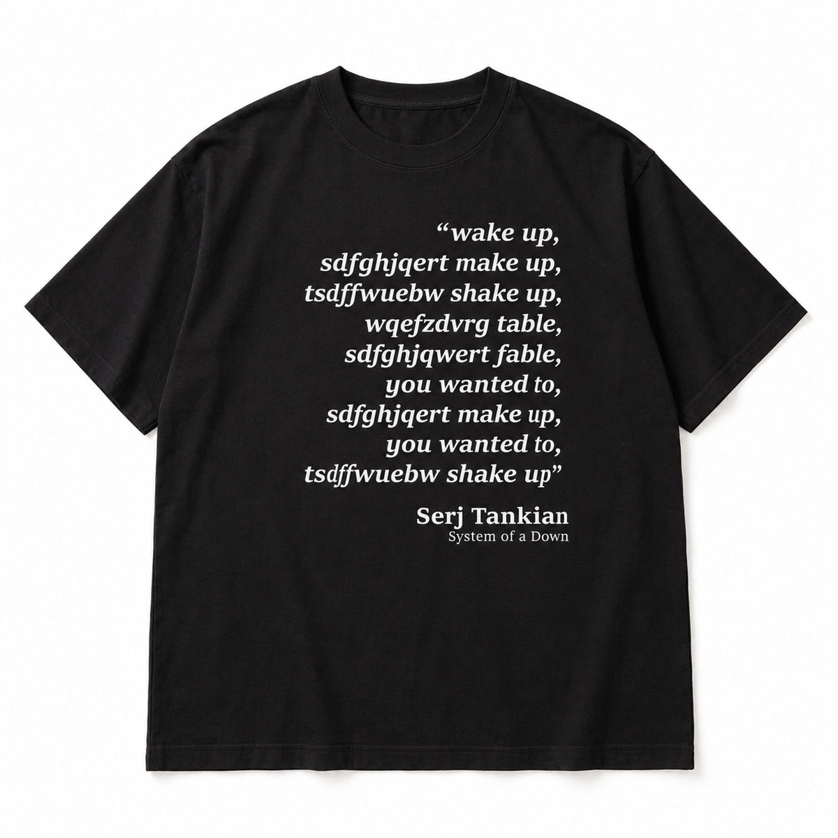 Black tee front flat lay with Wake Up scrambled text and Serj Tankian attribution