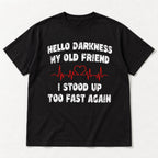 Hello Darkness My Old Friend black tee flat lay, front view with I Stood Up Too Fast Again punchline and red ECG-style graphic