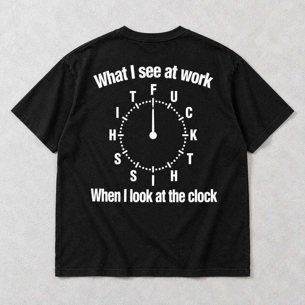 Black graphic tee back flat lay with What I See At Work lettering design