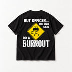 But Officer The Sign Said Do a Burnout yellow skidding-car sign graphic on black T-shirt back, flat lay showing complete print