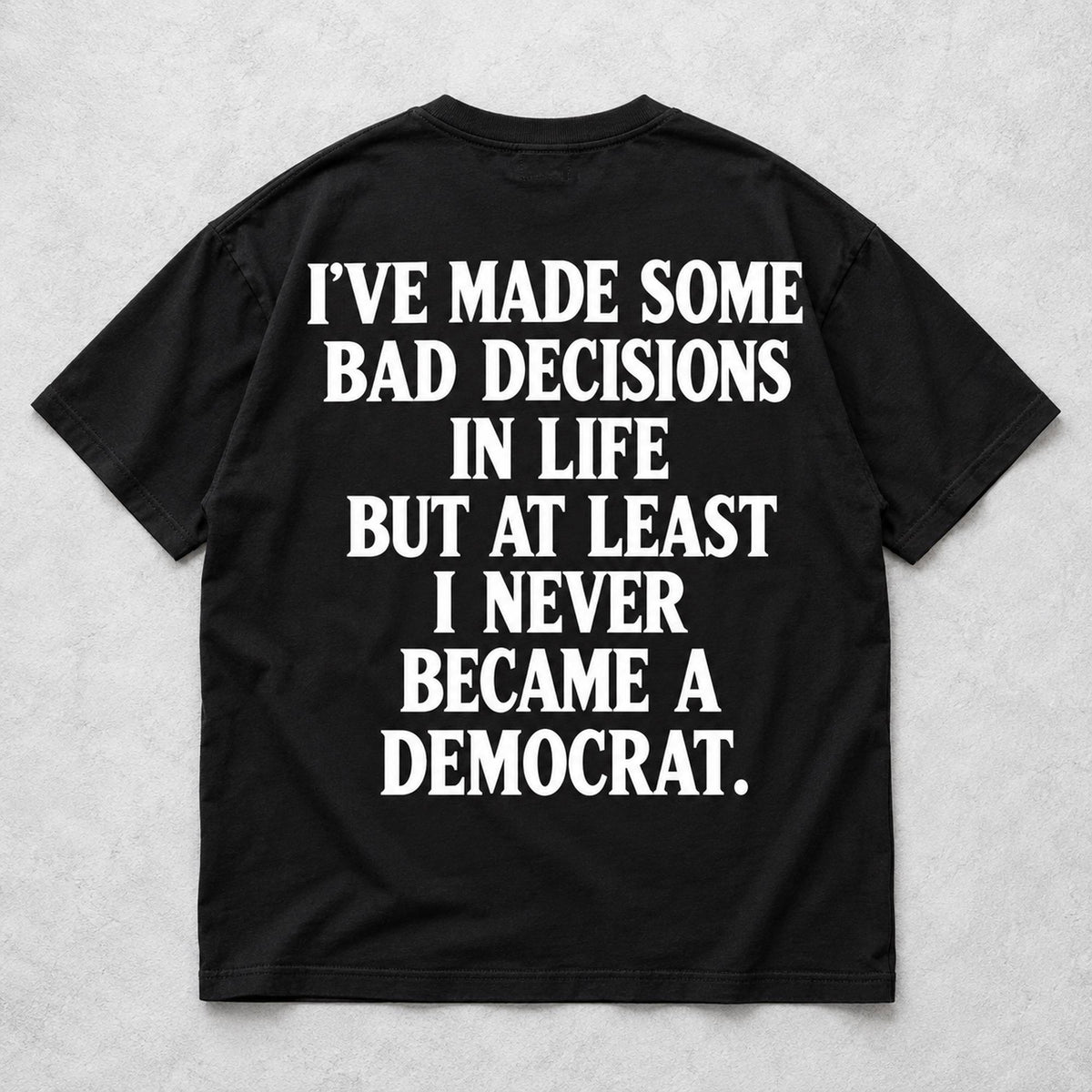 Never Became a Democrat statement black back-print tee flat lay