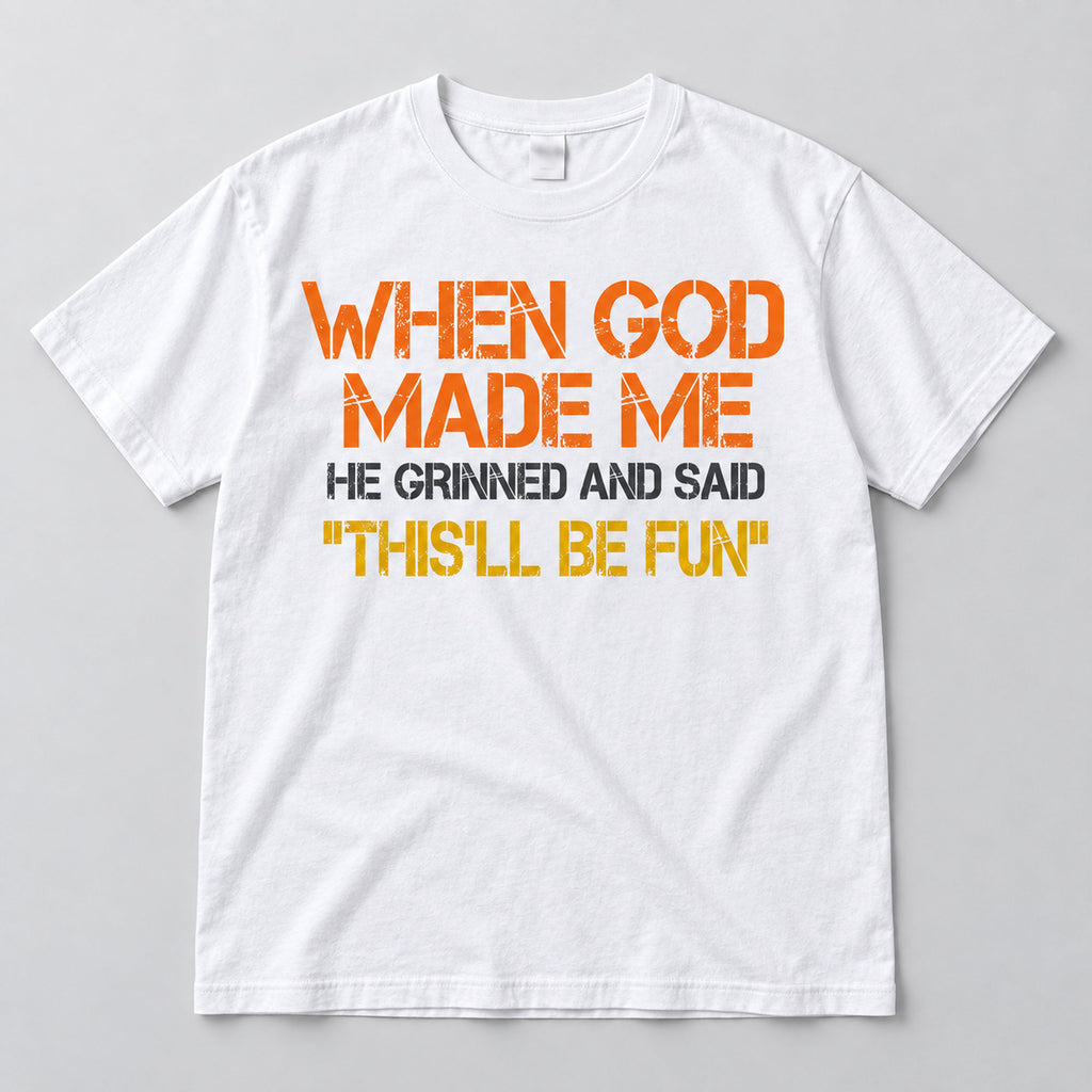 White This'll Be Fun graphic T-shirt laid flat from the front with the When God Made Me slogan in warm colors and charcoal