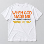 White This'll Be Fun graphic T-shirt laid flat from the front with the When God Made Me slogan in warm colors and charcoal