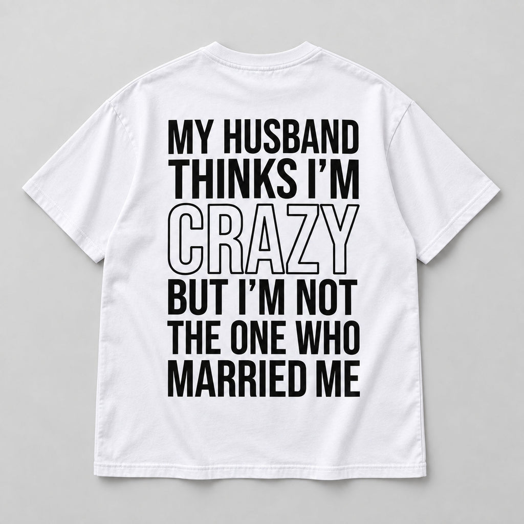 White marriage humor graphic T-shirt laid flat from the back with black lettering and the Married Me punchline