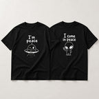 I Come In Peace matching couple alien graphic tee black front flat lay